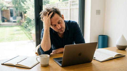 man feeling tired all day while sitting at desk during daytime